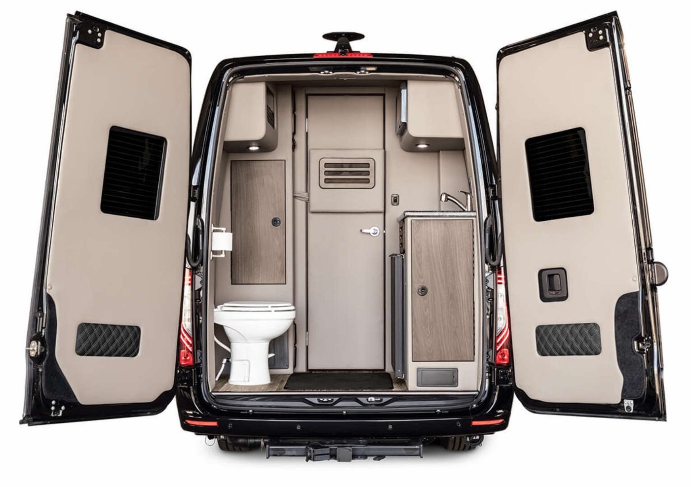 Rear doors of the Sprinter coach open to show the private lavatory and sink